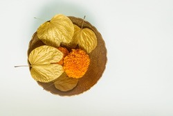 Symbolic golden leaves with marigold flowers in the bowl for the Dussehra occasion. Objects for Hindu festival ‘Vijayadashami’ or ‘Dashahara’ celebration.