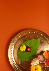 Betel nut and betel leaf placed in a puja thali as a symbolic God. Hindu religious objects for rituals. Top view of pooja plate with clear space.