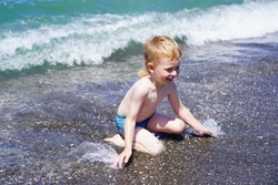 Ureki, Georgia - July 8, 2021: Boy swims in the sea