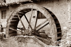 Rusty iron wheel of old mill water , 
Piedmont, Italy