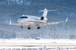 luxury business jet on short final at Samedan airport in the engadin valley. This airport is used by many business people to land on for their winter vacation in St.Moritz.