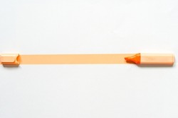 A highlighter in orange with an open cap.On orange and white paper