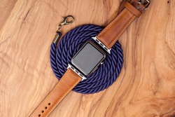 Smart watch, leather strap  on dark wood background
