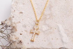 Silver cross necklace on beautiful background. Cross necklace image for e commerce, social media.