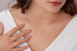Attractive female model cross silver necklace. Woman wearing religious jewellery. Jewelry photo for e commerce, online sale, social media.