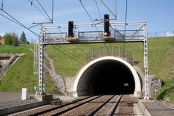 Railway and railroad track is goint into dark and long tunnel. Infrastructure building and underground passageway.