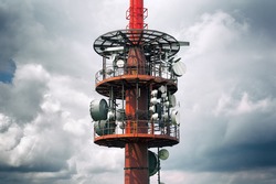 Transmission radio / tele tower - equipment for transmitting signal of mass communication mediums, radio and television. Stormy cloudy sky in the background