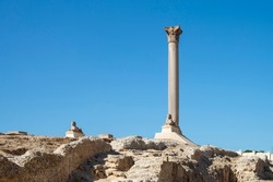 View of Pompey's Column with blue sky in the Serapeum of Alexandria, Egypt	
