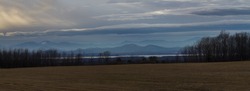 Lake Champlain in winter. Beautiful Mountain Panorama near Split Rock Mountain seen from Vermont. 