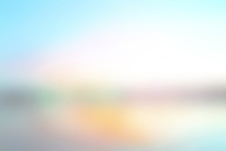 Summer holiday concept: concept: Abstract blur beach with yellow and blue sky sunrise background