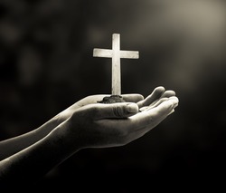 Good Friday concept: Human hands holding the wooden white cross.