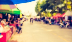 Abstract Blurred image of people walking at day market  on street for background usage . (vintage tone)