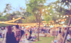 abstract blur image of  day festival  in garden with bokeh for background usage . (vintage tone)