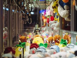 Claw Machines Toy Arcade game with stuffed animal toys on carnival. Entertainment for children in the amusement park