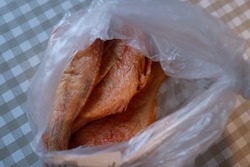 Fresh whole hot smoked sea bass in a bag. Three fish.