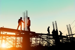 Silhouette construction industry engineer standing orders for worker
 team to work safety on high ground over blurred background sunset pastel