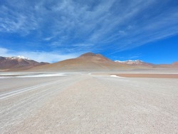 A road between two salt lakes in the stone desert of Bolivia near the city of Uyuni. Eduardo Avaroa Andean Fauna National Reserve