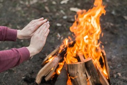 bonfire - woman hands warming 