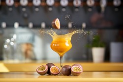 Passion fruit, splashing into a pornstar martini cocktail.