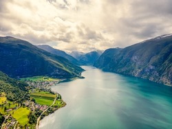 Norway - High Dynamic Range landscape view from above of Norwegian Fjords in the route from Bergen to Tyssedal. Drone shot, HDR, cloudy sky, morning light. Beautiful panorama.