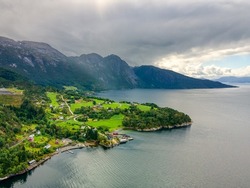 Norway - Nature around the road from Bergen to Tyssedal. Landscape of the Norwegian fjords. Drone shot, HDR, cloudy sky, morning light. Beautiful green panorama.