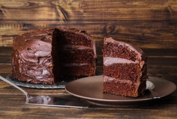 Chocolate food devil's cake on dark wooden background captured in low key formate