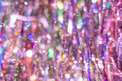 Abstract multicolored purple rainbow background. Defocused light streaks tinsel with bokeh effect.