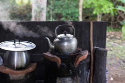 Boiling water in the aluminum kettle, get the heat from the gas stove, it's put on the chinese earthen stove.