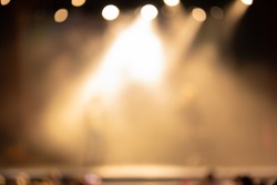 Texture blur and defocus, background for design. Stage light at a concert show. Artists perform on scene in light and smoke.