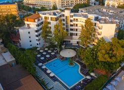 Panoramic aerial view of large swimming pool with bar at luxury tropical hotel apartment resort. Rhodes, Greece, Europe