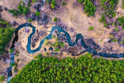 Aerial landscape of winding river in green field, top view of beautiful nature background from drone.