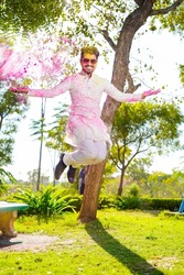 Indian young man playing with the color in holi festival