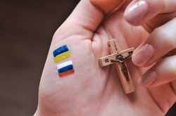 Orthodox Christ and drawned Russian and Ukrainian flags in hand. translation from Russian :Jesus Christ 