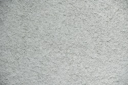 close-up grunge gray concrete wall texture background, cement walls are decorated with plastering techniques to have rough surface like cement dripping for decoration exterior facade building wall