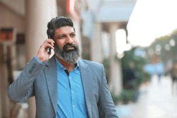 Indian businessman talking on mobilephone.