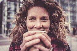 Woman In Her Forties Warming Her Hands On Coffee Cup