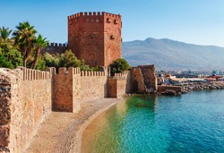 Kizil Kule tower in Alanya peninsula, Antalya district, Turkey, Asia. Famous tourist destination with high mountains. Part of ancient old Castle. Summer bright day