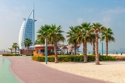 Cityscape with beautiful park with palm trees in Dubai, UAE