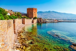 Kizil Kule tower in Alanya peninsula, Antalya district, Turkey, Asia. Famous tourist destination with high mountains. Part of ancient old Castle. Summer bright day