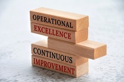 Operational excellence and continuous improvement text on wooden blocks. Business concept.