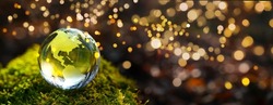 2021 to 2022 new year background. Green glass globe with green moos and golden lights - sustainable environment.