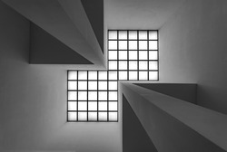 Bright quadratic roof windows with vanishing point and symmetry. Abstract black and white grey scale perspective. Inside a modern room from floor to ceiling.