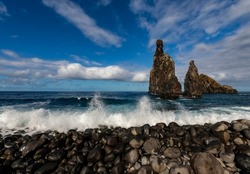 “Mirador Ilheus da Ribeira da Janela“ is a rocky beach on the north coast of Madeira island Portugal near Porto Moniz. Formation of 3 high rocks with characteristic shape protrudes from the sea.