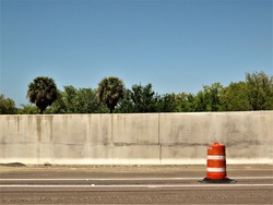 Florida highway with orange and white traffic barrel