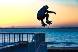 young man jumps with his skateboard