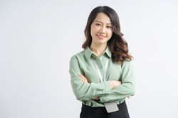 Portrait of the beautiful asian businesswoman with arms crossed on a white background
