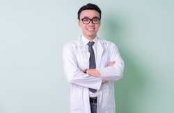 Asian doctor standing on green background