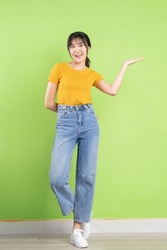 Young Asian woman posing on green background