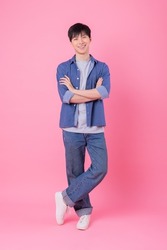 Young Asian man posing on pink background
