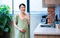 Young Asian woman pregnant relax at home